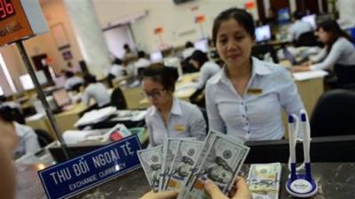 Việt Nam không hạ giá tiền tệ